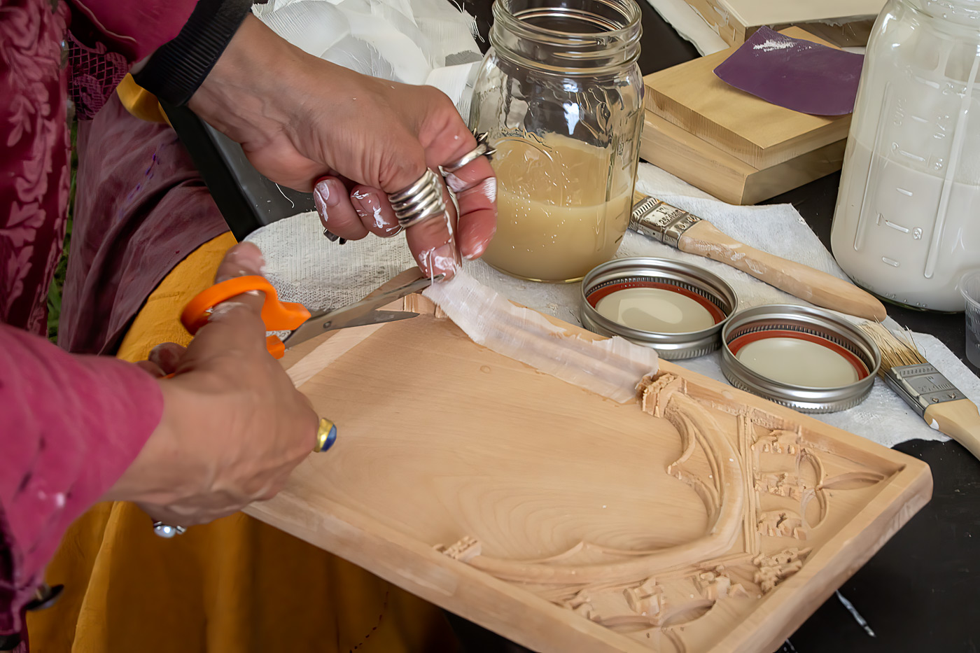 Linen strips being laid into the carved surface